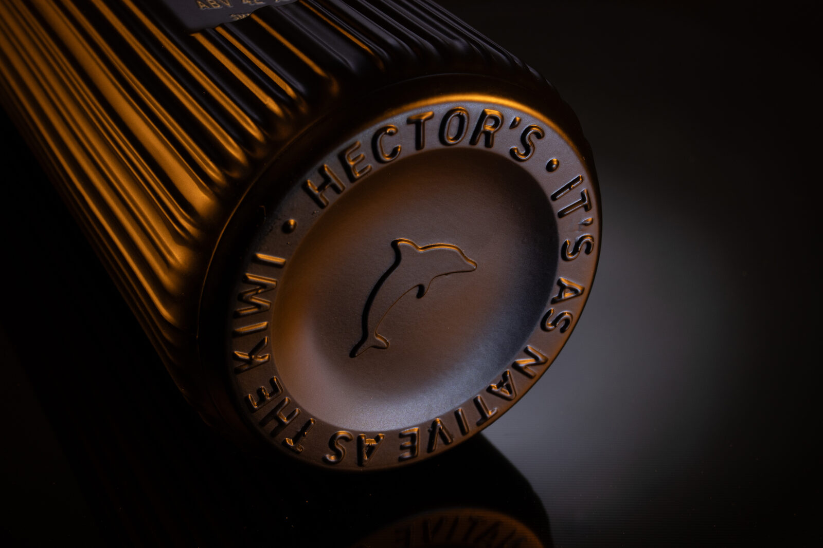Hector's dolphin and tagline embossed into the base of the bottle